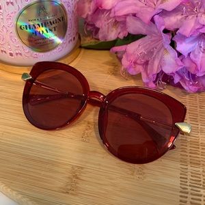 Red sunglasses with gold accent